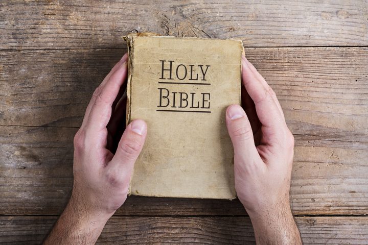 Bible and praying hands
