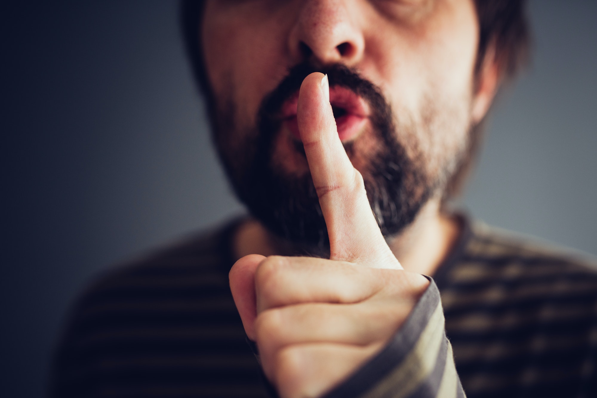 Man saying hush or be quiet