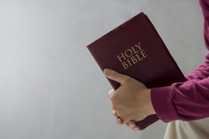 Bible concept.Man reading bible and praying to god before work.