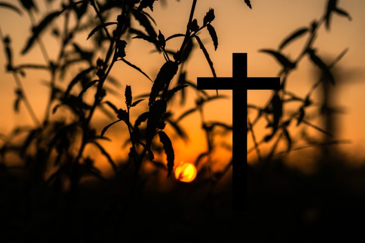 Cross christian god religion on sunset background